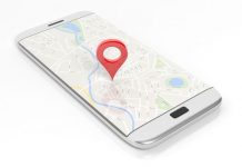 Smartphone with map and red pinpoint on screen, isolated on white background.