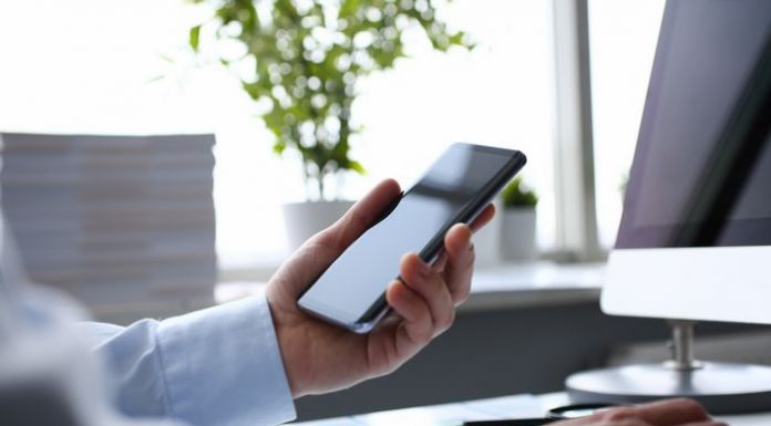 Businessman hipster holds telephone background